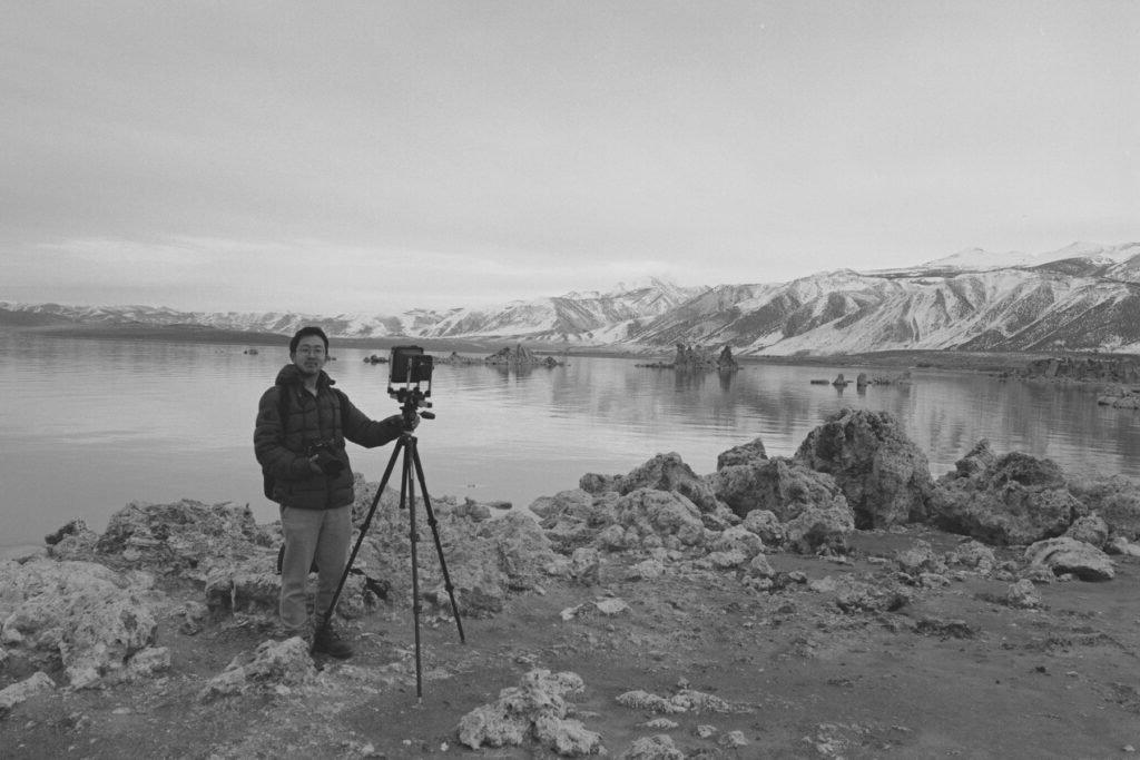 beihua guy poses in front of mono lake with his camera